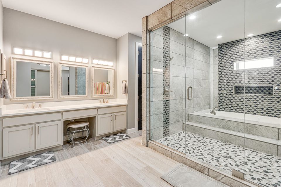 Finished ALES bathroom remodel with a glass shower and custom tile
