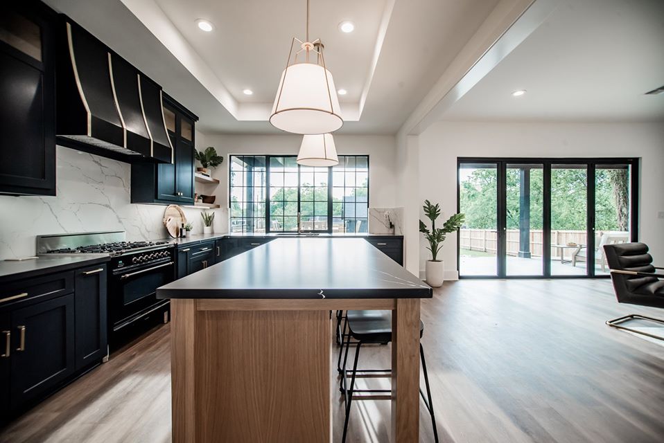 Finished ALES kitchen remodel with dark cabinetry and a large wood island