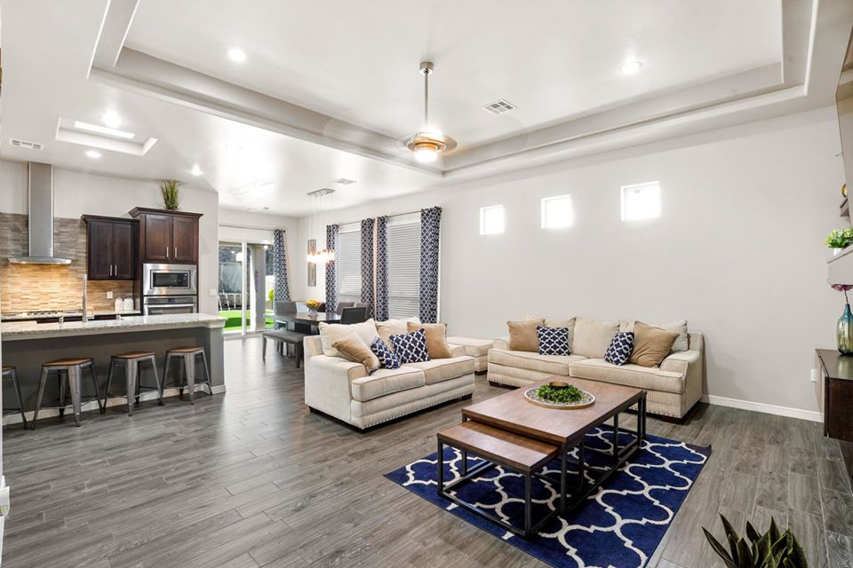 Bright remodeled living room connected to a kitchen